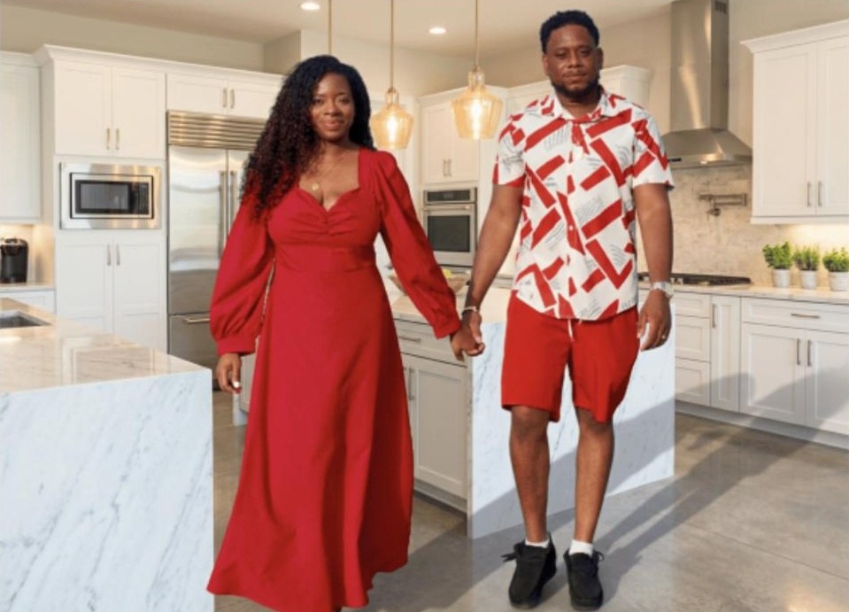 Brithany and Rackesh Neath, the husband-and-wife team behind Jerk Tavern, in matching red outfits in their kitchen